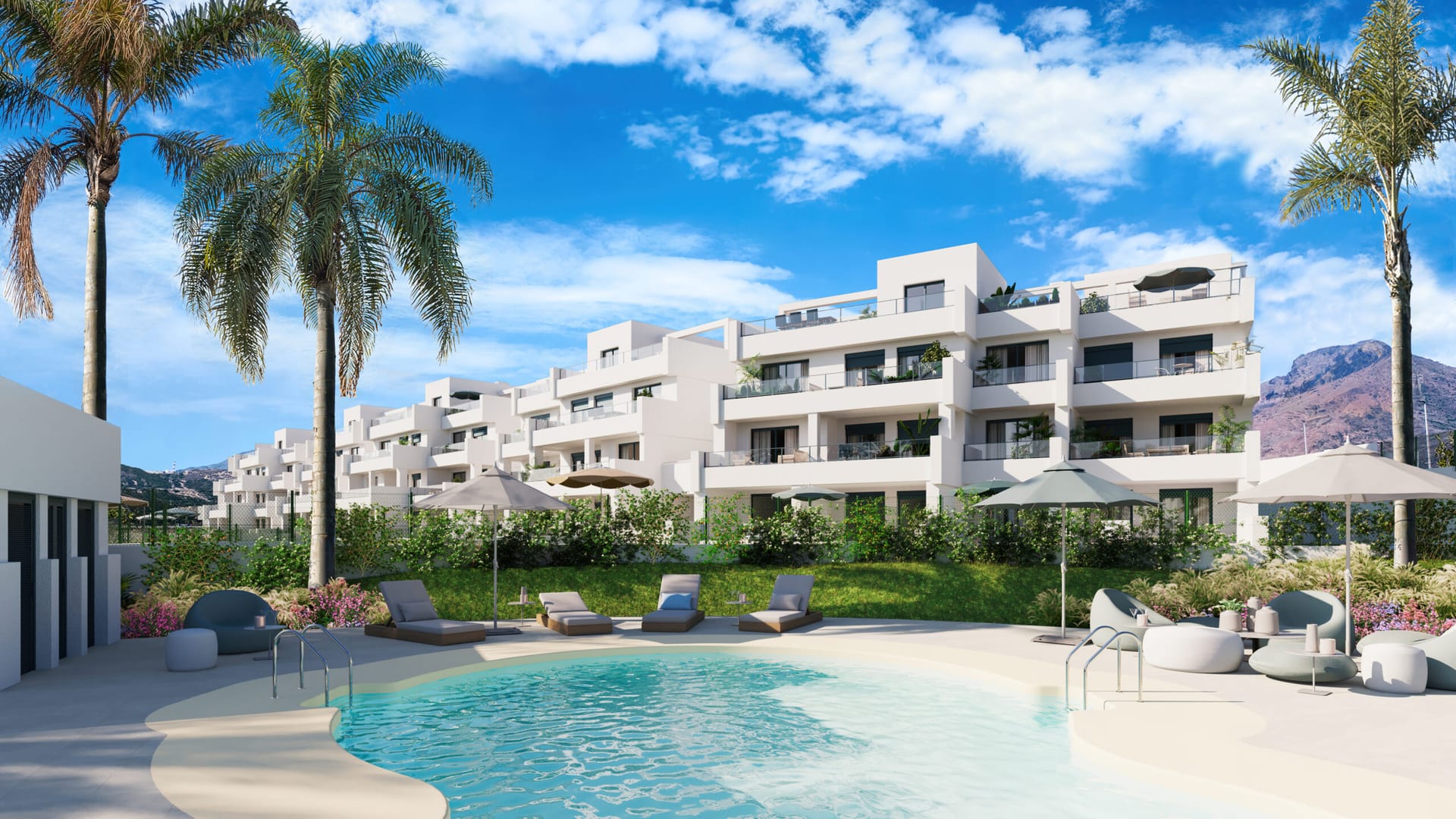 The shared pool with a shallow, sandy edge, loungers and palm trees, and the white apartment buildings behind with mountains beyond. Aby Middle, Estepona Golf, Estepona.