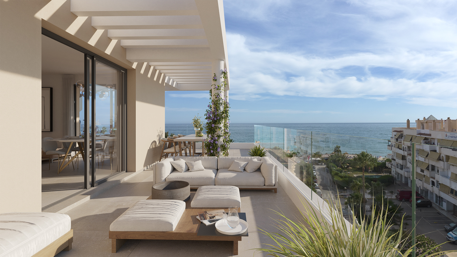 A terrace, with a sofa, a fire pit table and open sea views over the rooftops below. Almara Residences, Benagalbón, Rincón de la Victoria.