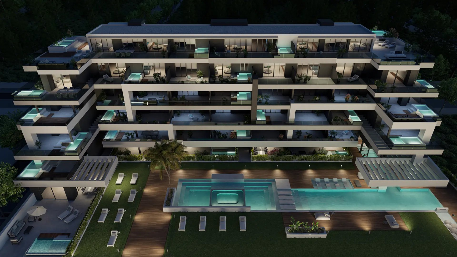 The new development from the air at night, with the shared pool in front of it and a small pool lit on many of the terraces. Almitak, Parque de las Lagunas, Mijas.