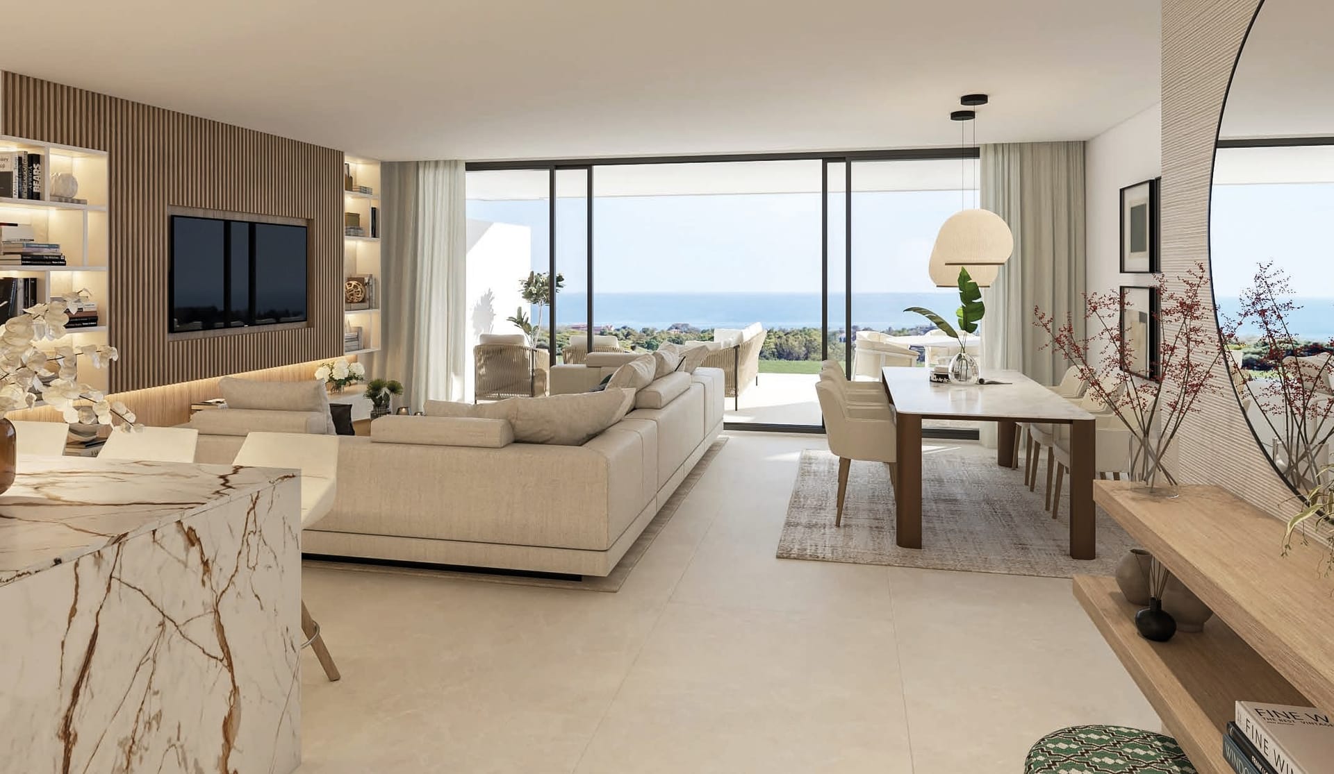 A living room in the brochure, with a long sofa, a dining table and floor-to-ceiling glass looking over the valley to the sea. Aloha Forest, Los Pinos de Aloha, Marbella.