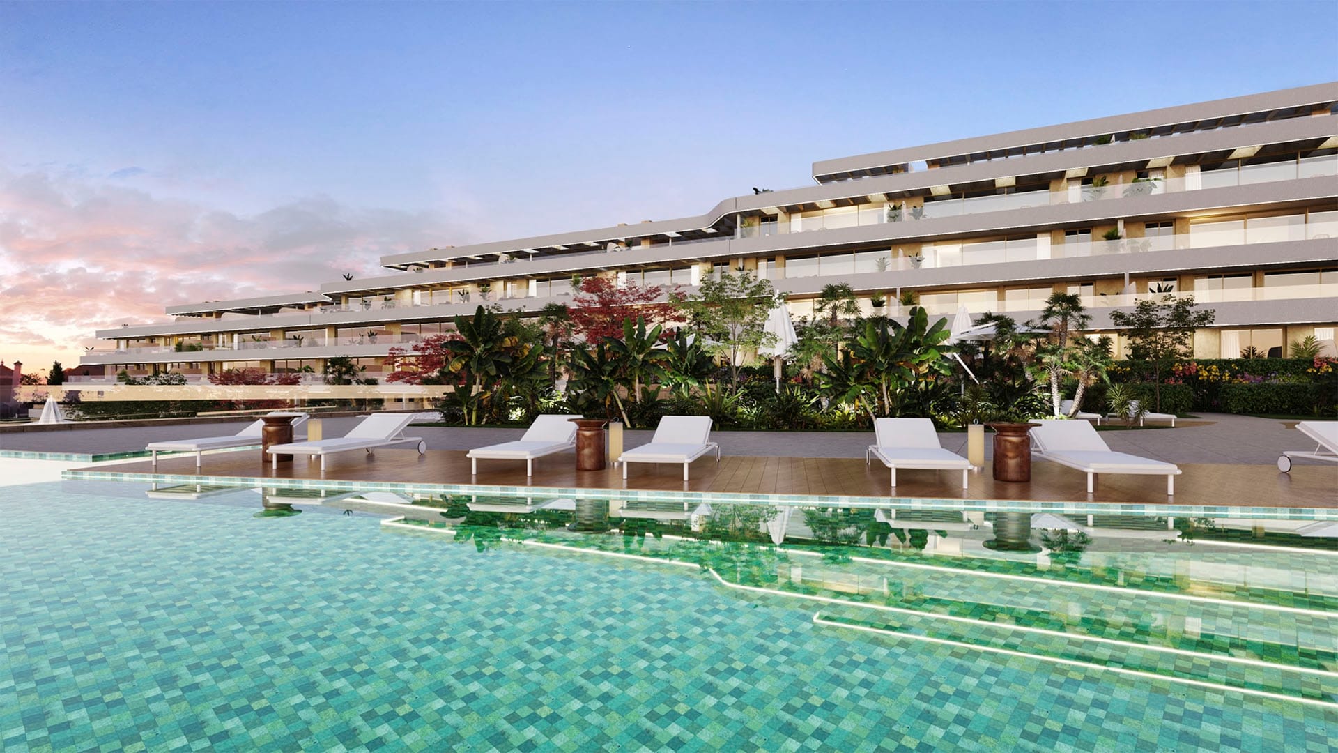 The pool at dusk, with the terraced floors of the building behind it. Arosa, Torrenueva, Mijas.