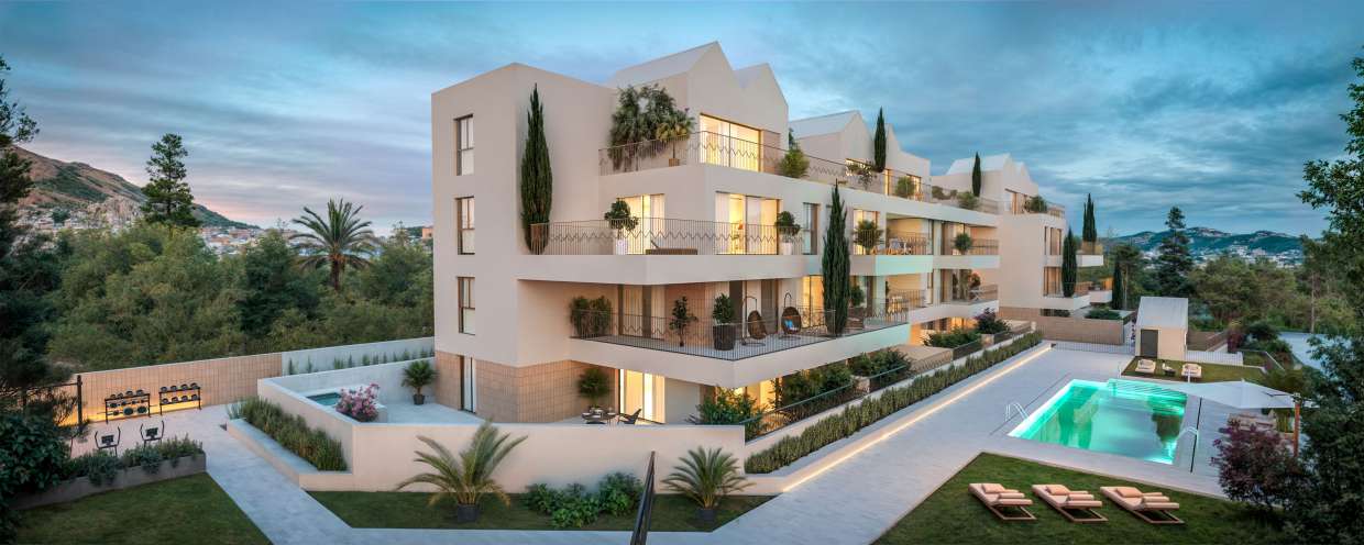 The building at dusk, with the communal pool on the right and a ground-floor patio with its own pool on the left. Art Marina, La Carihuela, Torremolinos.