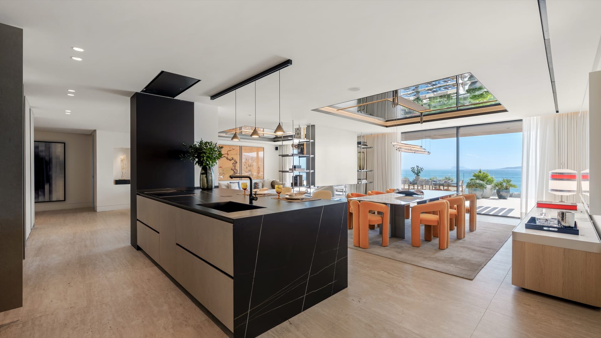 An open kitchen and dining room, with the sea through the glass. Atelier 4, Playa del Cristo, Estepona.