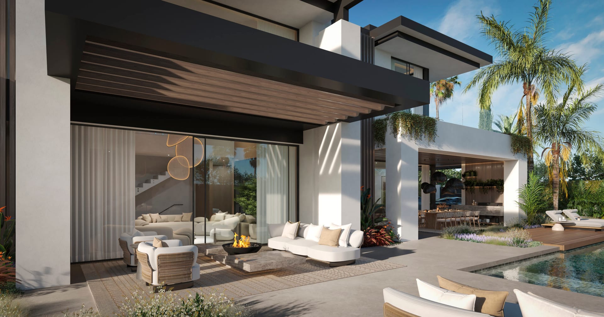 The covered terrace beside the pool, with seating around a fire. Blume, San Pedro de Alcántara, Marbella.