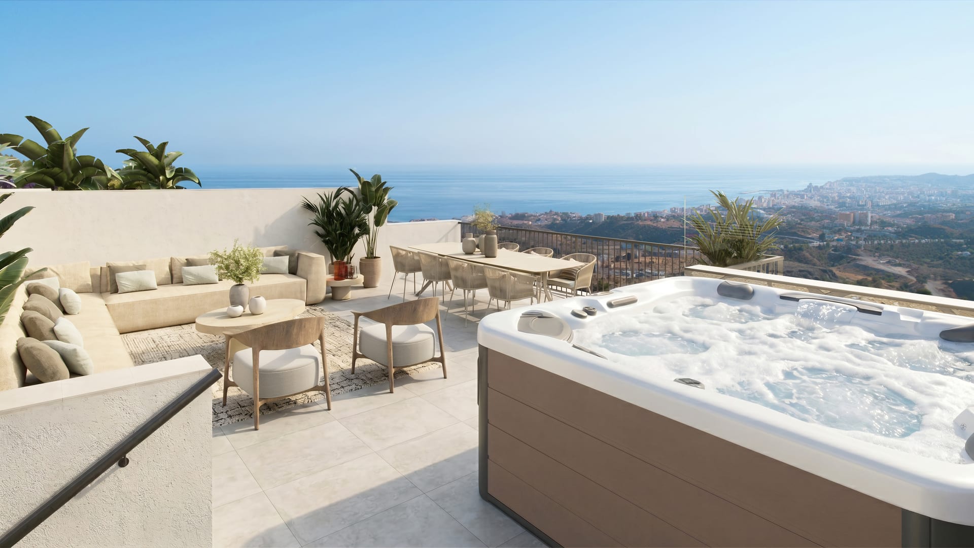 The roof terrace of a villa, with its hot tub, an outdoor sofa and a dining table, looking over the coast to the sea. Buenavista Views, Buenavista, Mijas.