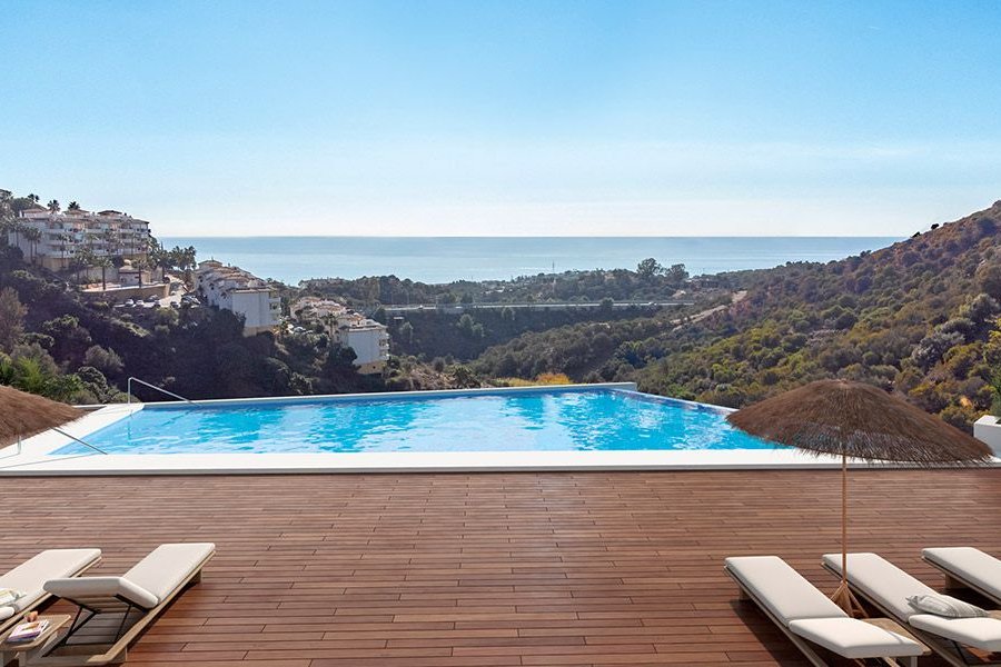 The infinity pool and the deck around it, looking down the wooded valley towards the sea. Calahonda Sunset, Calahonda, Mijas.