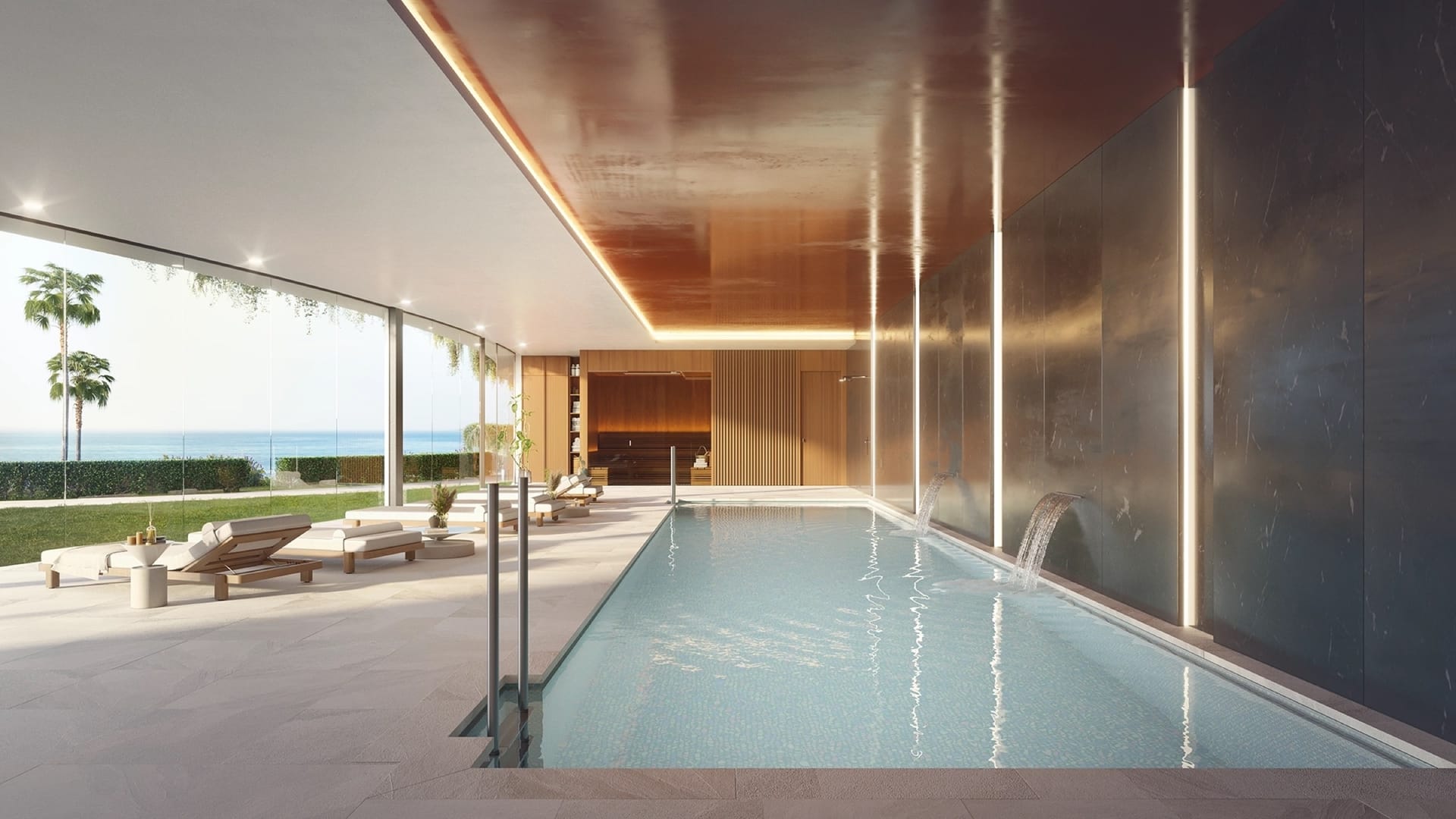 The heated indoor pool, with glass along one side facing the gardens. Casatalaya Residences, Torremuelle, Benalmádena.
