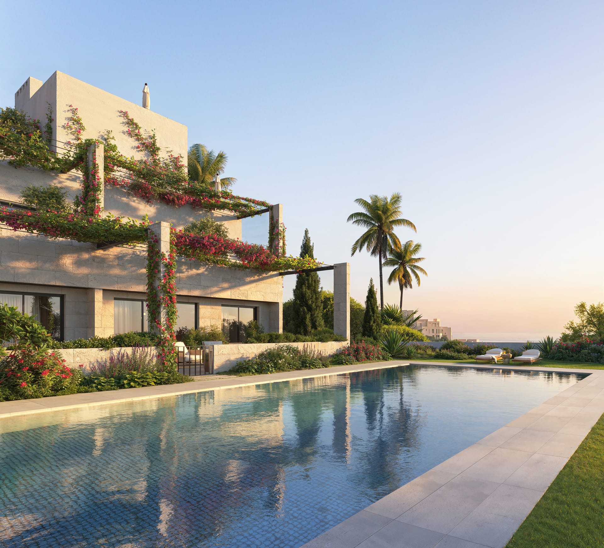 The long pool at sunset, with planted terraces stepping up beside it. ERA Residence, New Golden Mile, Estepona.