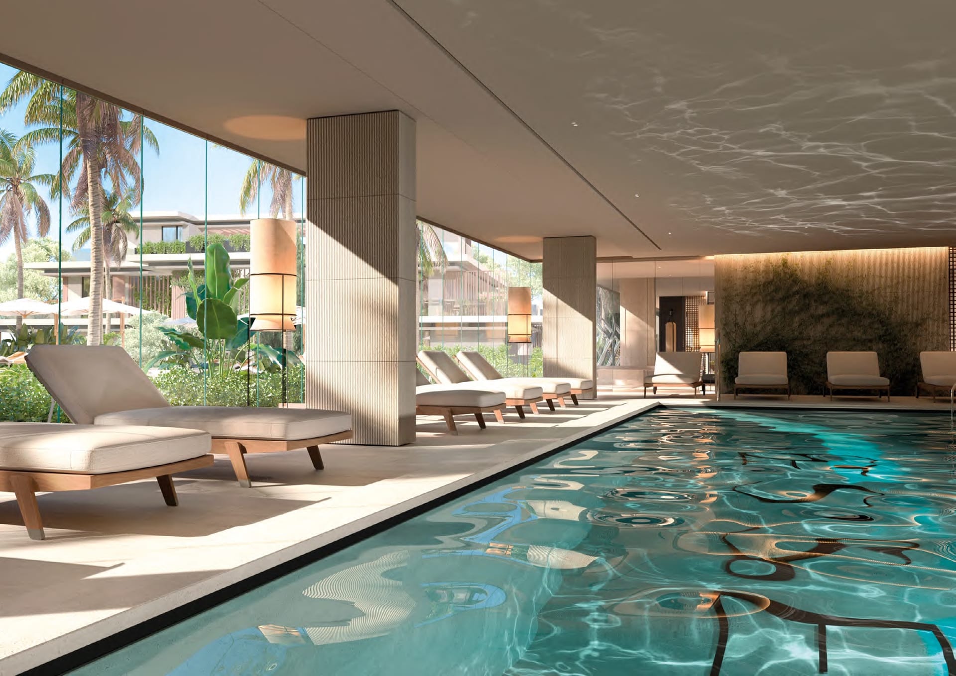 The heated indoor pool, with loungers beside it and glass along one side looking onto the gardens. Essence Residence, Cancelada, Estepona.