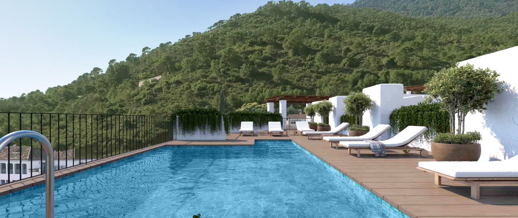 The rooftop pool and its loungers, with the wooded hillside rising beyond the railing. Fuente Lirios, Calle Fuente de Lirios, Benahavís.