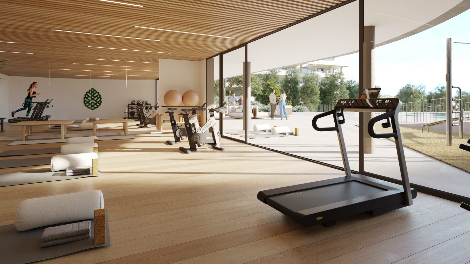 The gym, its glass wall opening straight onto the pool terrace. Greenity, Las Lagunas de Mijas, Mijas.