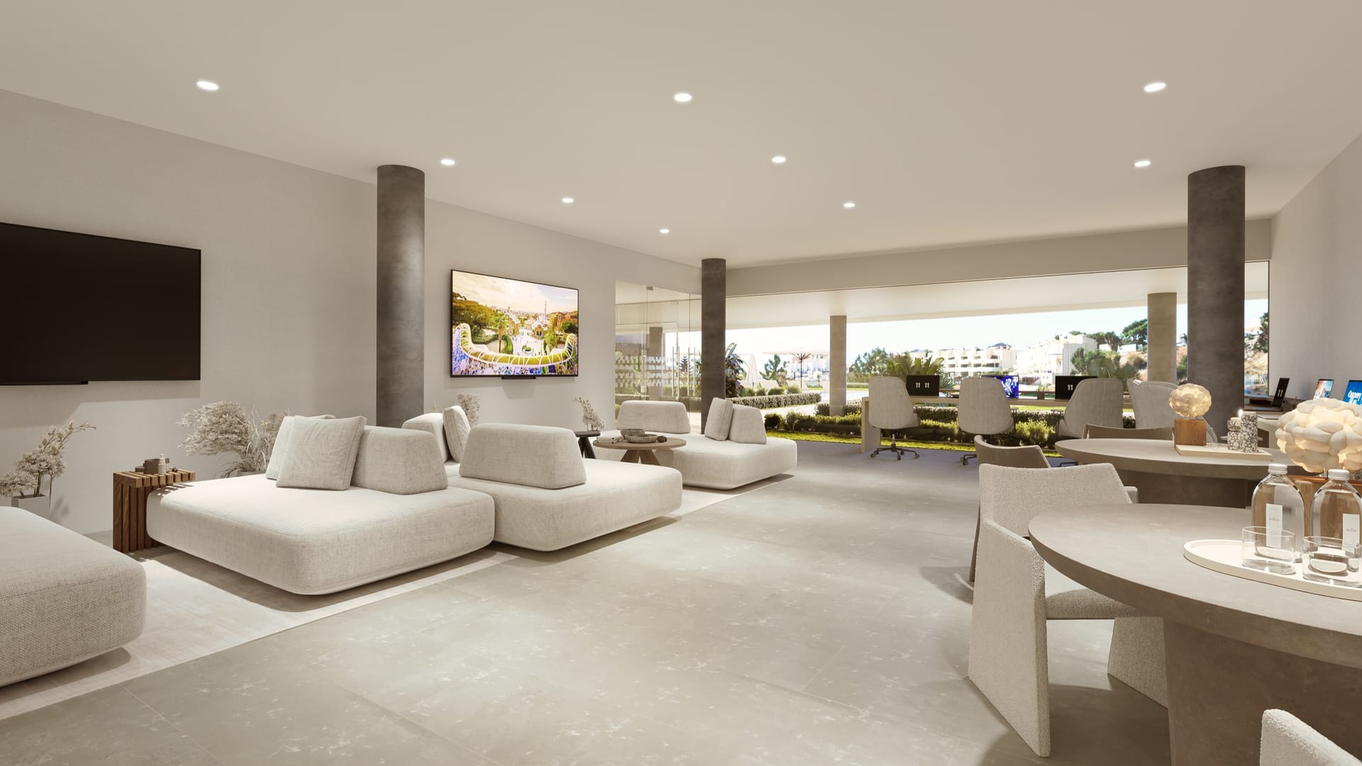 The coworking room, with sofas and desks facing a glass wall onto the gardens. Korall Residences, El Higuerón, Fuengirola.