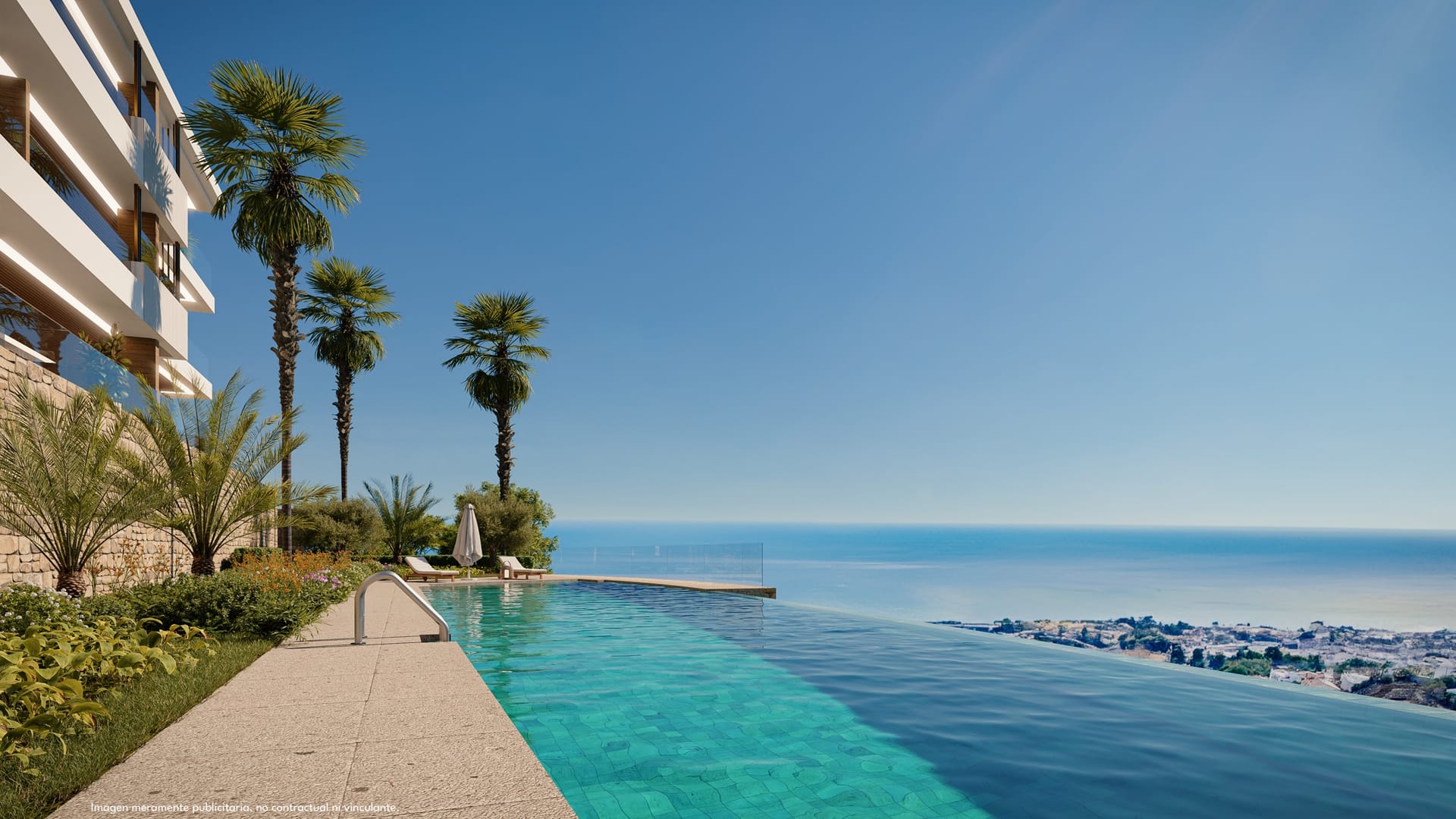 The infinity pool along the edge of the gardens, with the sea beyond it. Lomas Unique, El Higuerón, Fuengirola.