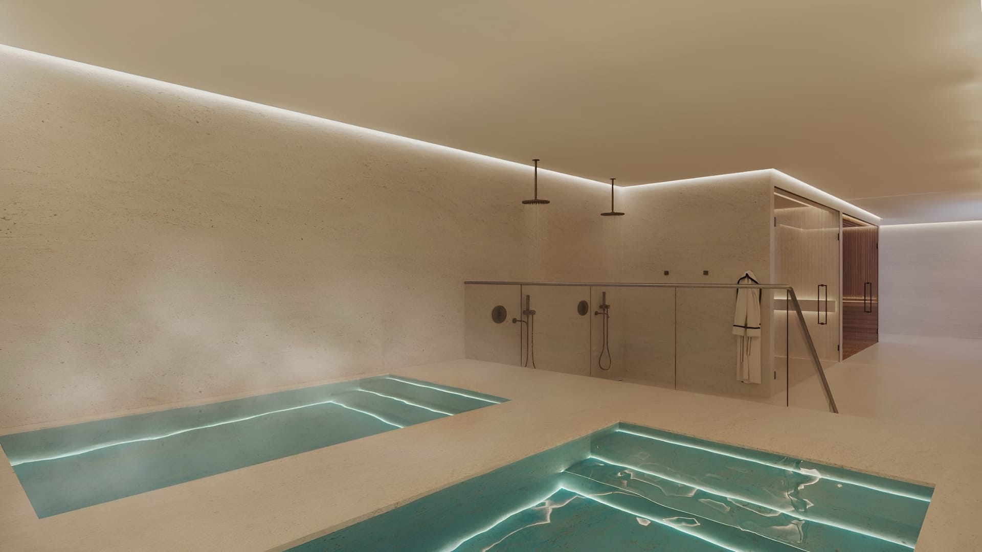 The spa, with two plunge pools set into the floor and showers along the wall. Lomas Unique, El Higuerón, Fuengirola.