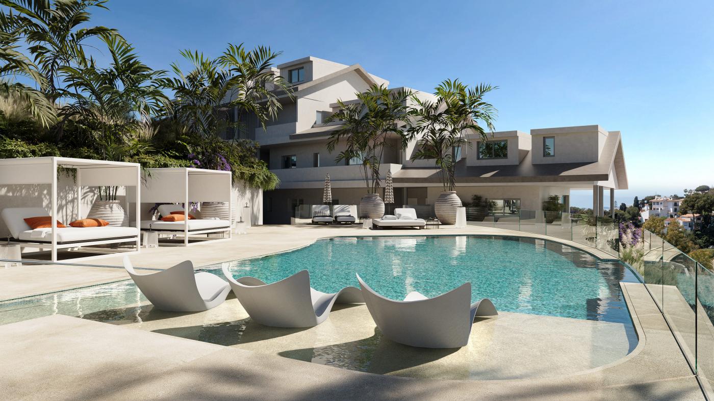 The pool, with loungers set into the shallow water and shaded daybeds along the far side. Macan Beach Residences, Torrequebrada, Benalmádena.
