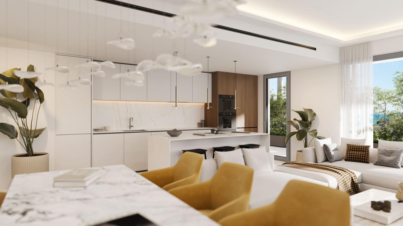 The kitchen and dining area, finished in white with a pale stone island. Macan Beach Residences, Torrequebrada, Benalmádena.