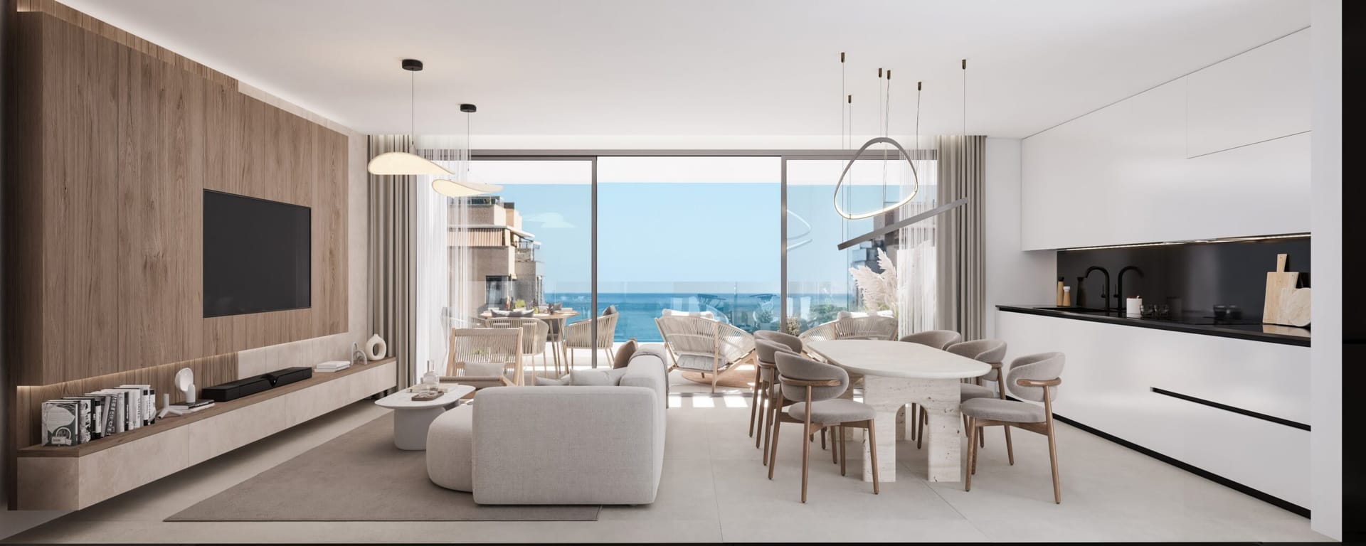 The living room and kitchen, open to each other, with the sea beyond the windows. Milabeka, Calle Milagrosa, Málaga.
