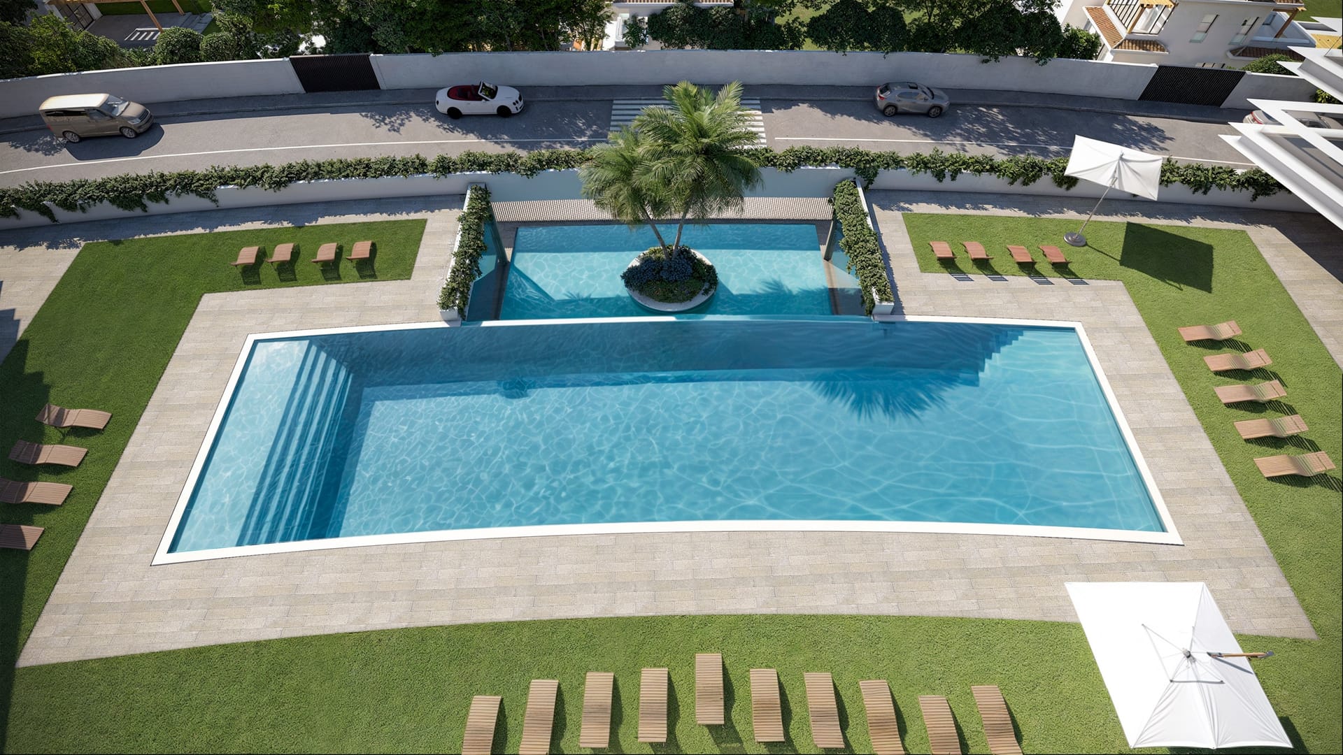The communal pool from above, set in lawn with loungers along each side and a raised pool at the far end. Moon 64, Los Hidalgos, Manilva.