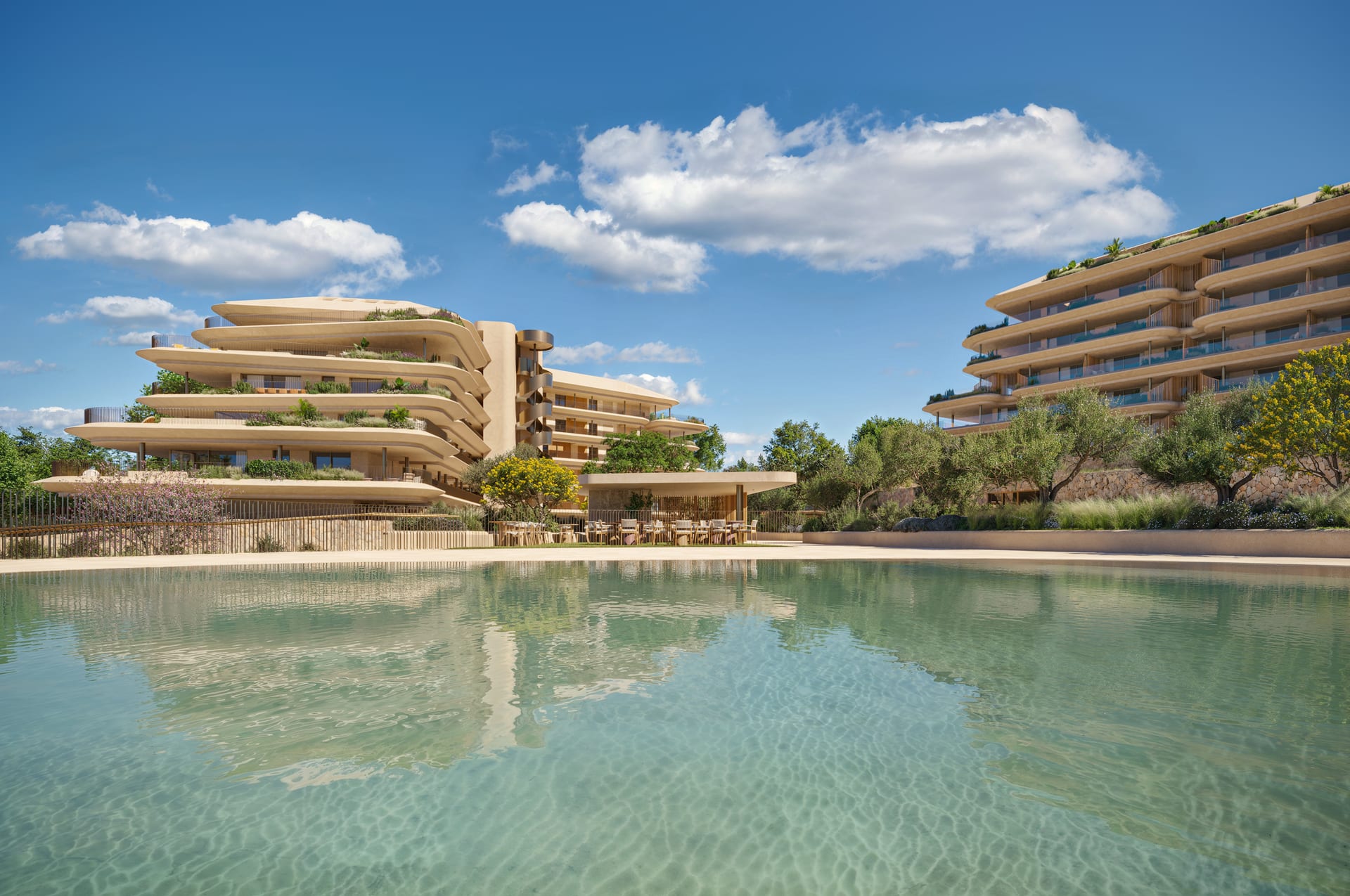 The large outdoor pool, with two of the curved buildings and a covered pavilion beyond it. Naven, Los Pacos, Fuengirola.