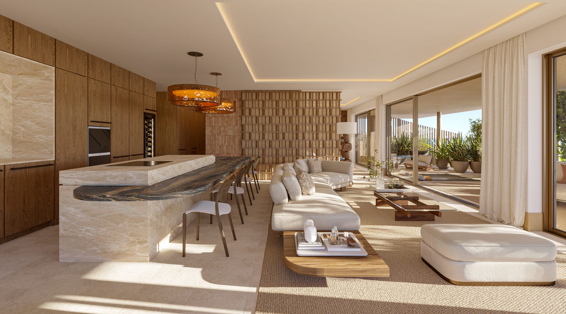 A kitchen and living room in one space, with a long island in a pale veined finish, timber units, and the terrace beyond through glass doors. Naven, Los Pacos, Fuengirola.