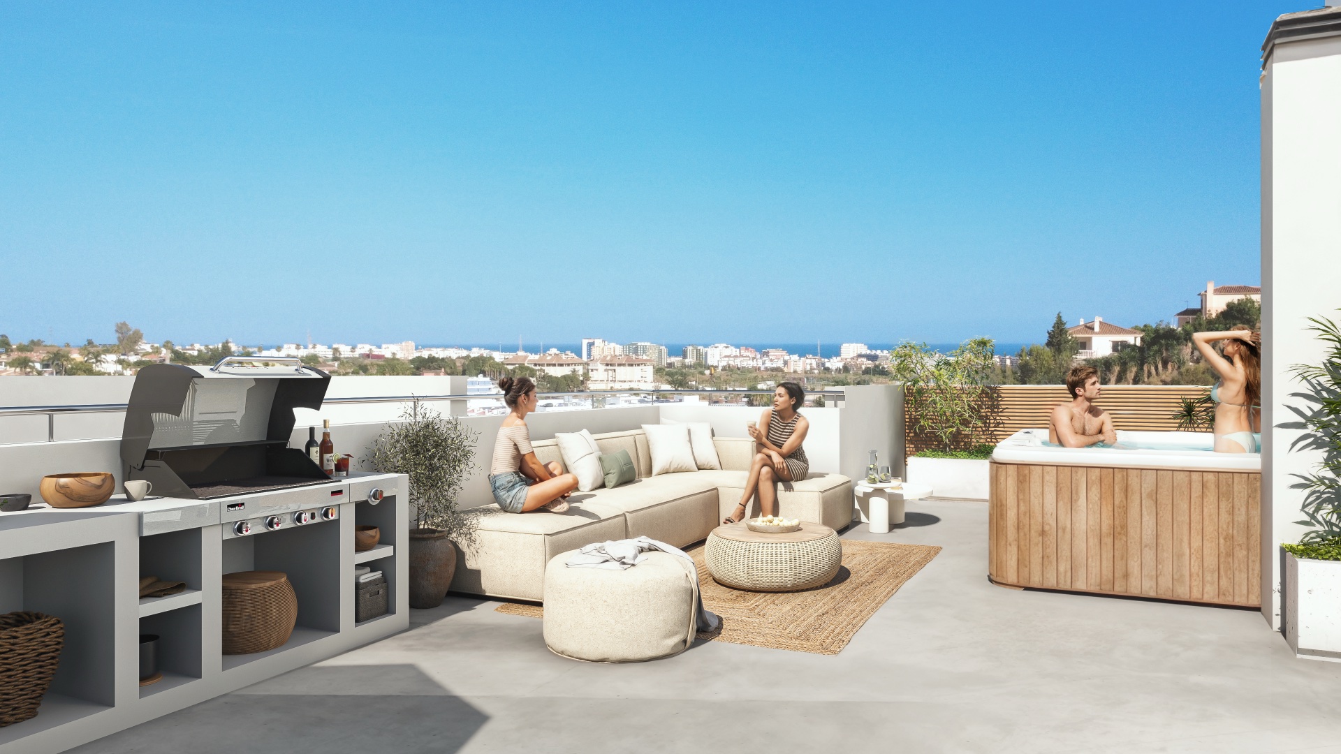 The roof terrace of a top-floor home, looking down across Fuengirola to the sea. Oceanic Garden, El Lagarejo, Mijas.