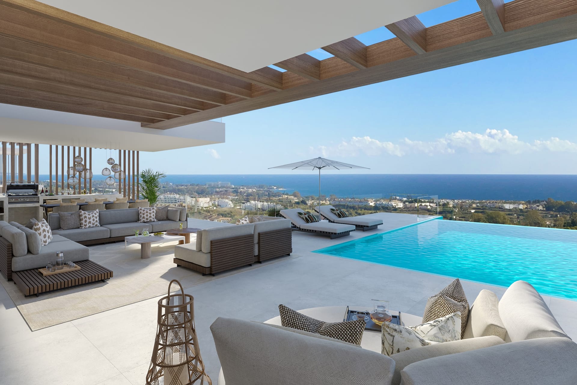 A terrace with a pool and outdoor seating, looking out to sea. Ocyan Villas, La Resina, Estepona.