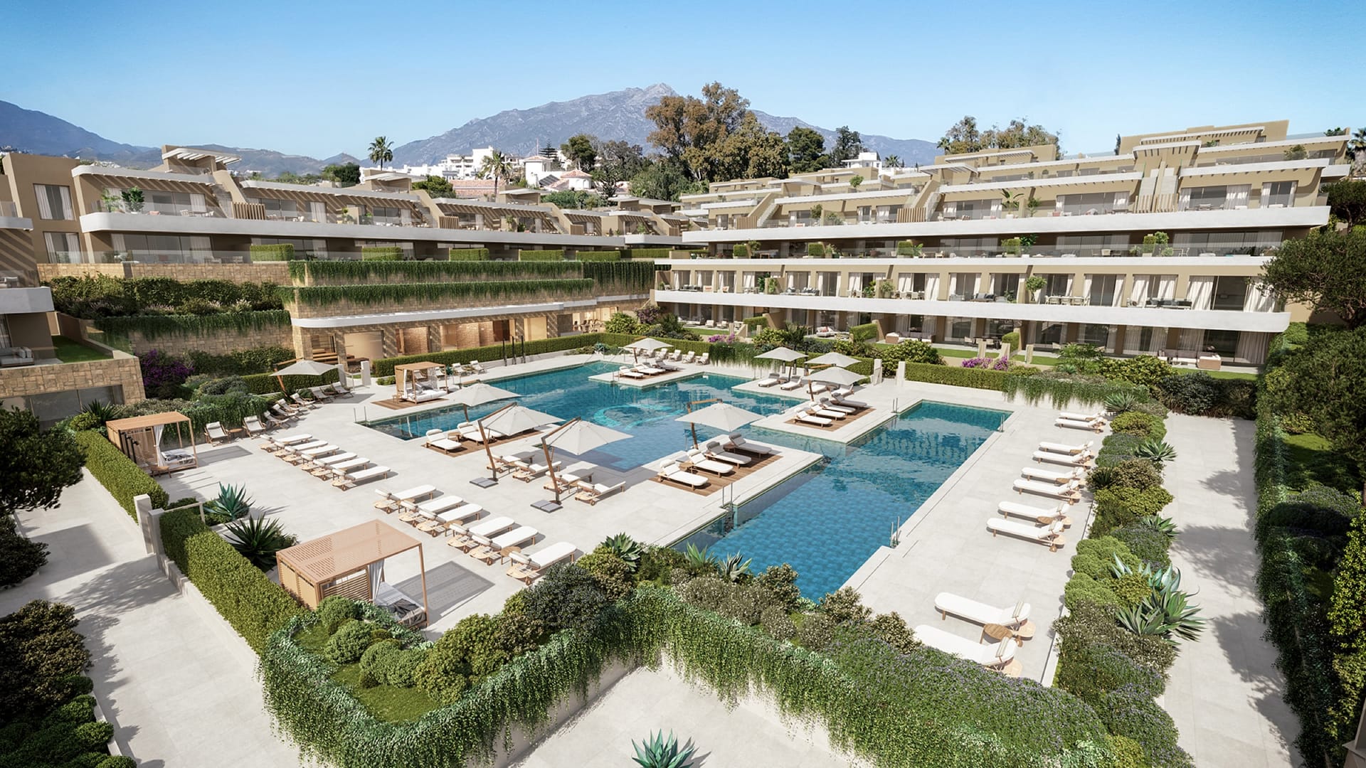 An aerial view of the buildings around their pools, with La Concha mountain behind. Omnia, New Golden Mile, Estepona.