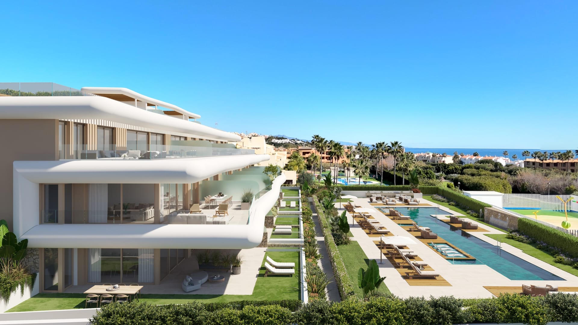 The shared pool with its long swimming lane, beside the building and its gardens. Privilege Suites, Casares Costa, Casares.