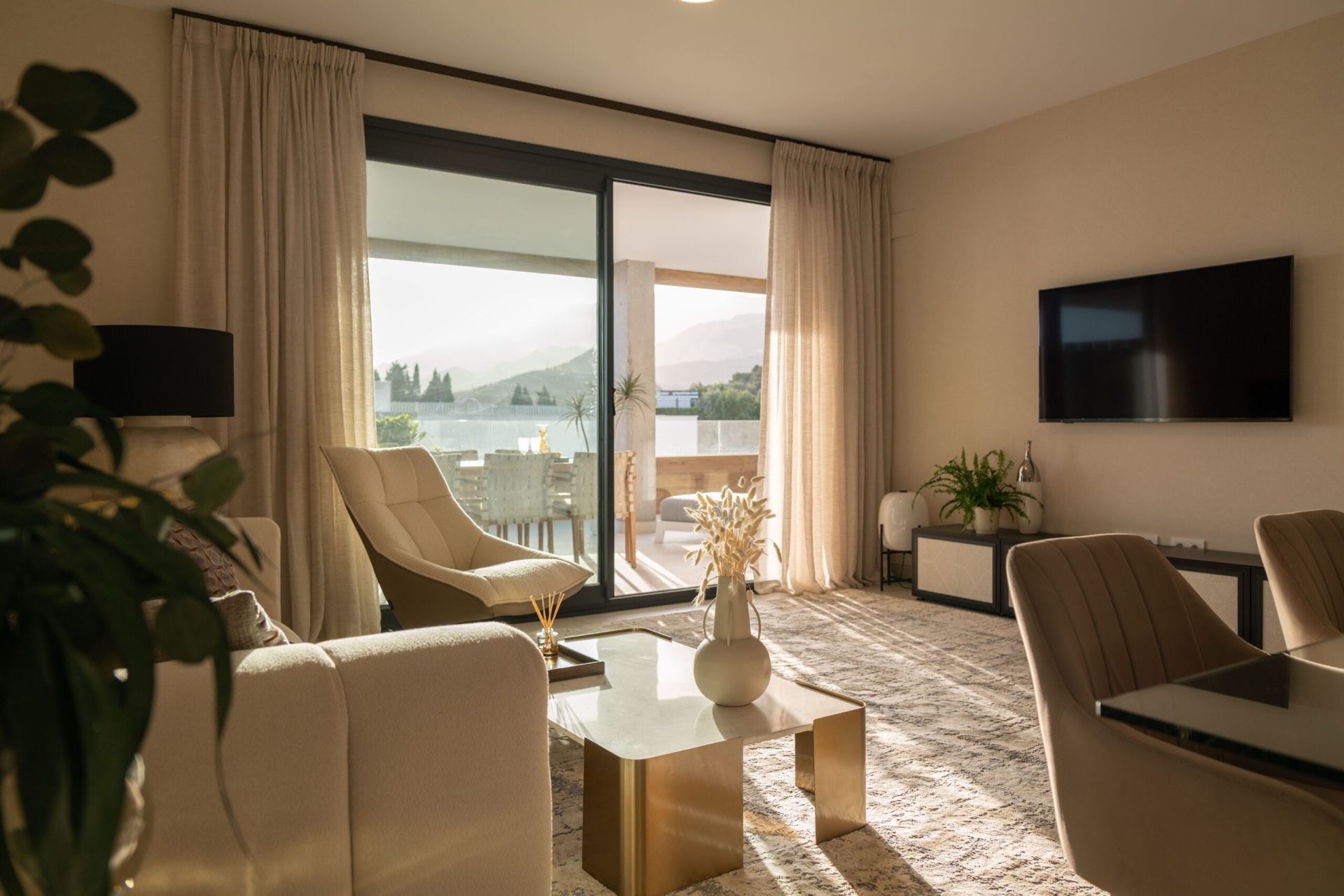 The living room of the show home, looking out to the terrace. Quintessence, Altos de los Monteros, Marbella.