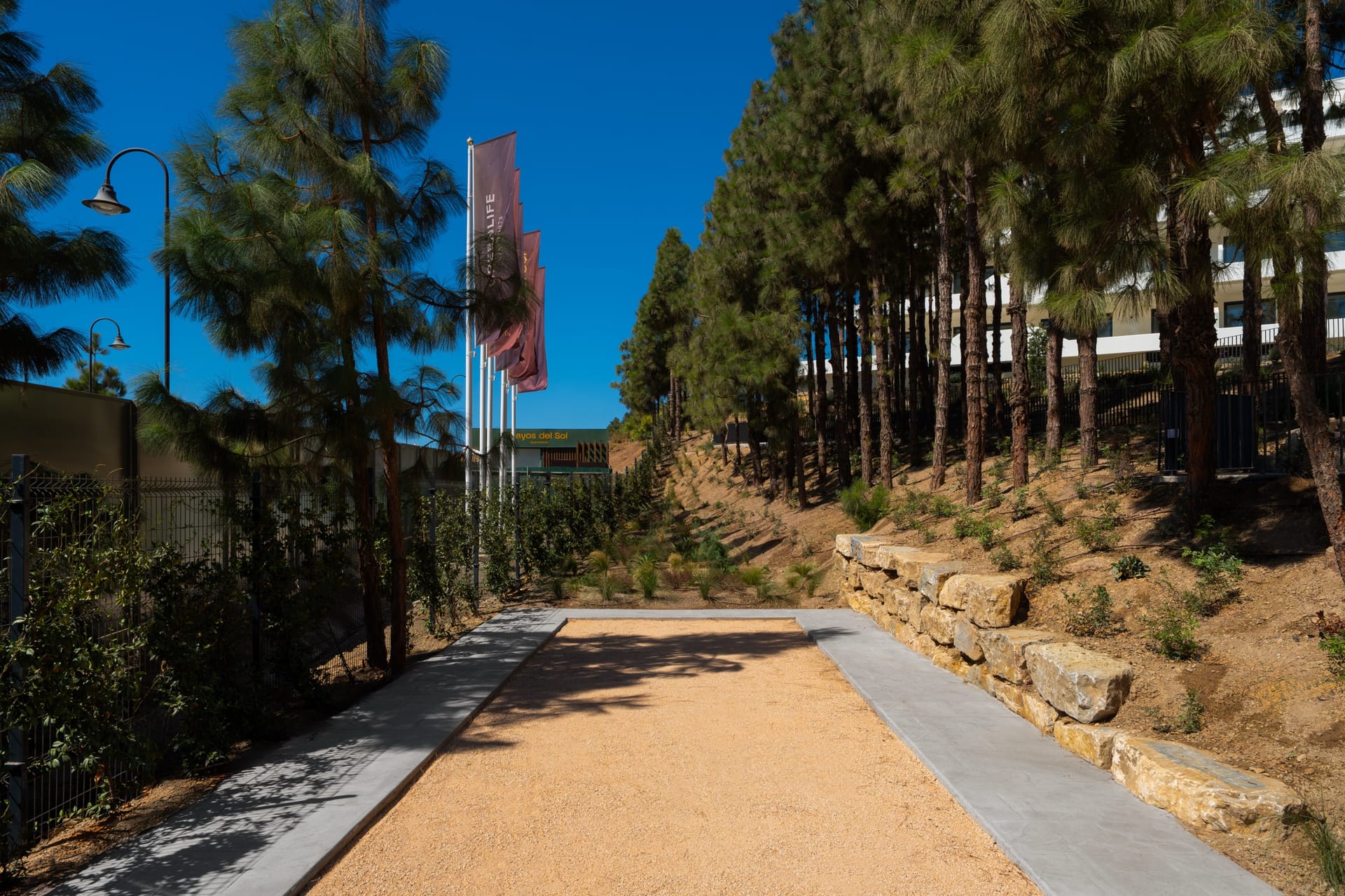 The petanque court, laid in gravel under the pines at the edge of the grounds. Rayos del Sol, El Chaparral, Mijas.