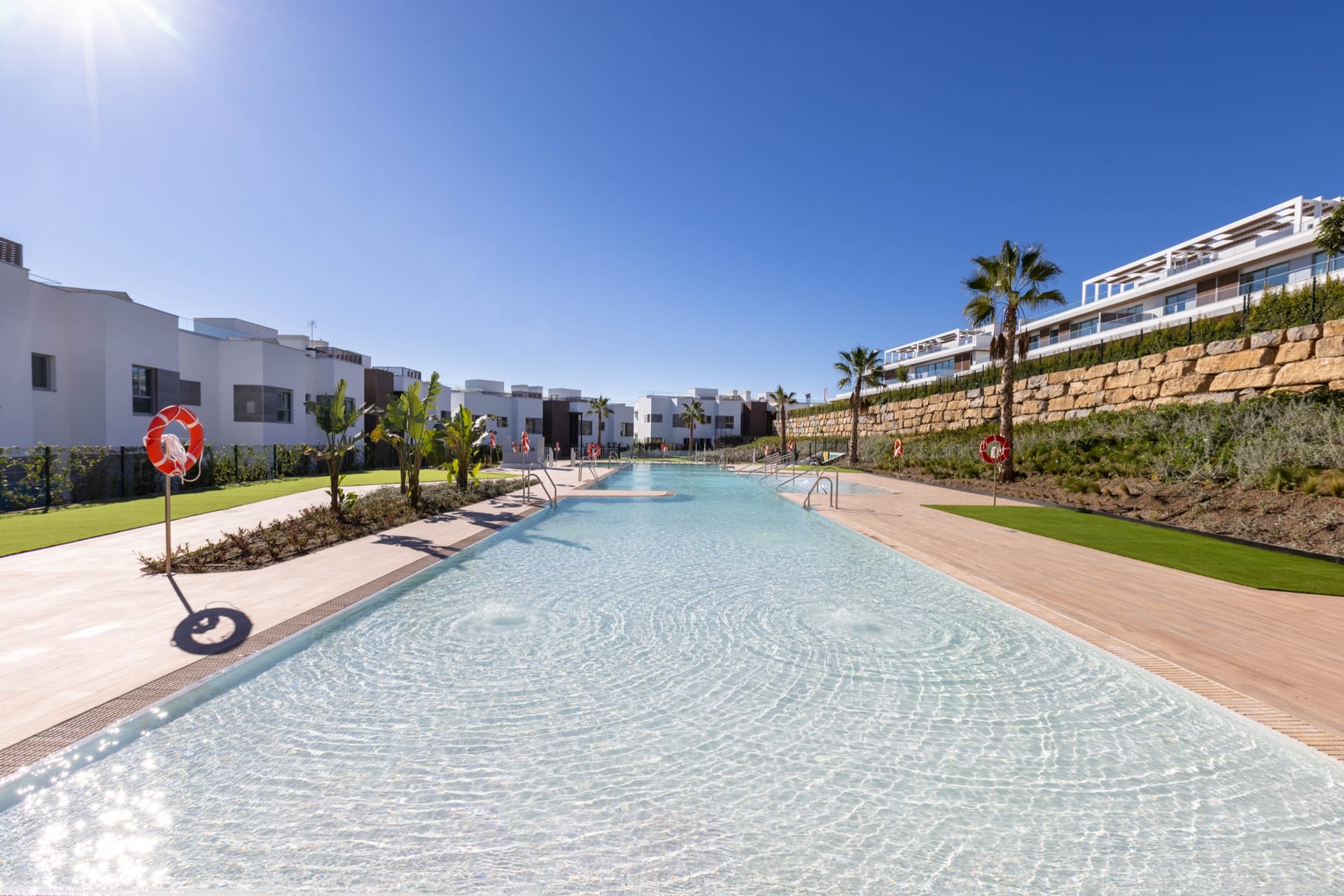One of the two outdoor pools, with the apartments behind it. Santa Clara Homes, Los Monteros, Marbella.