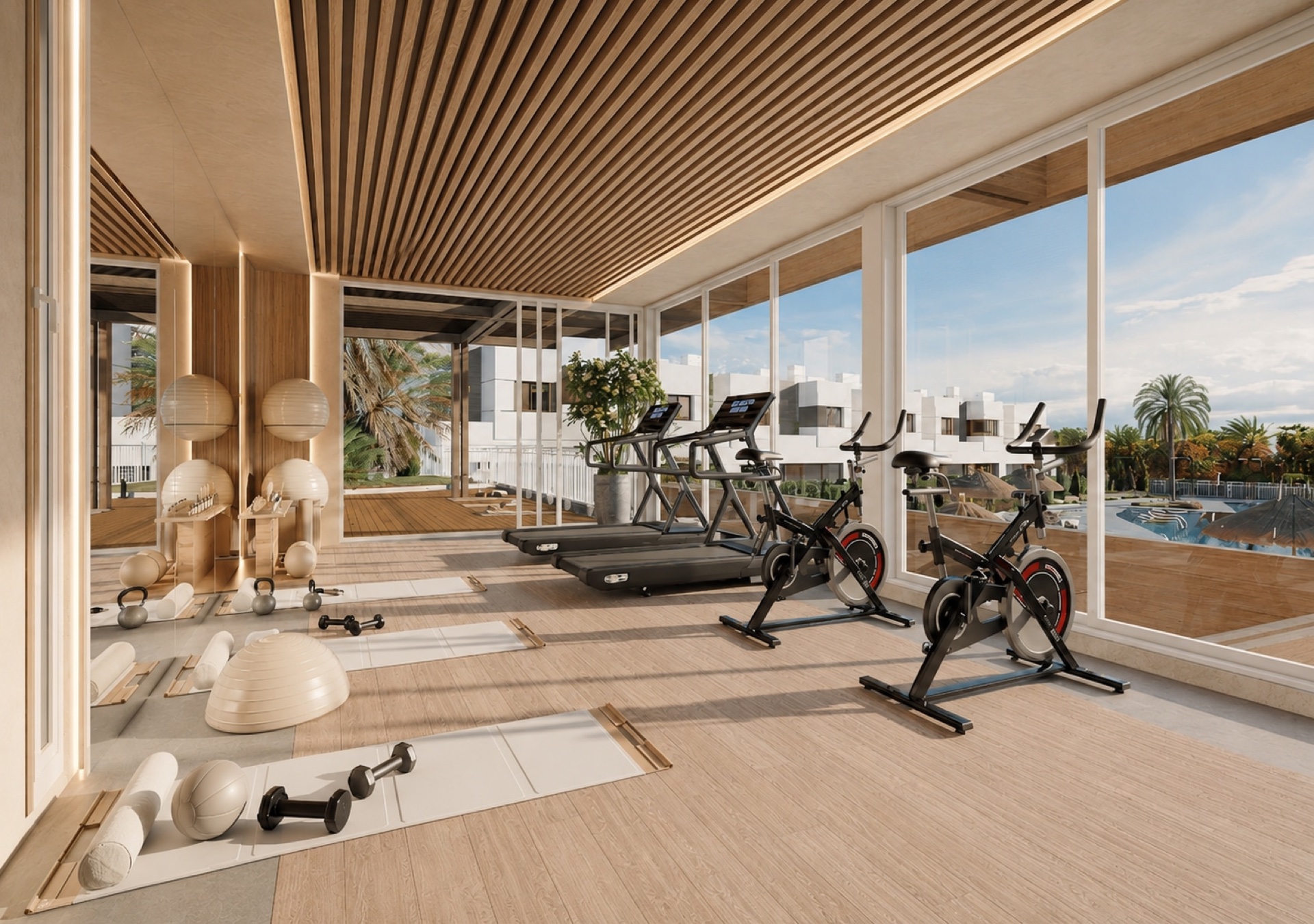 The gym, with its own cardio machines and free weights, and a wall of glass looking over the pool. Savia, Hipódromo, Mijas.