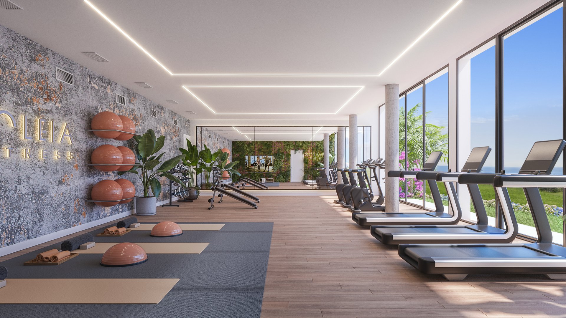 The gym, a long room of running machines and weights with glazing down one side onto the pool terrace. Soleia Living, El Chaparral, Mijas.
