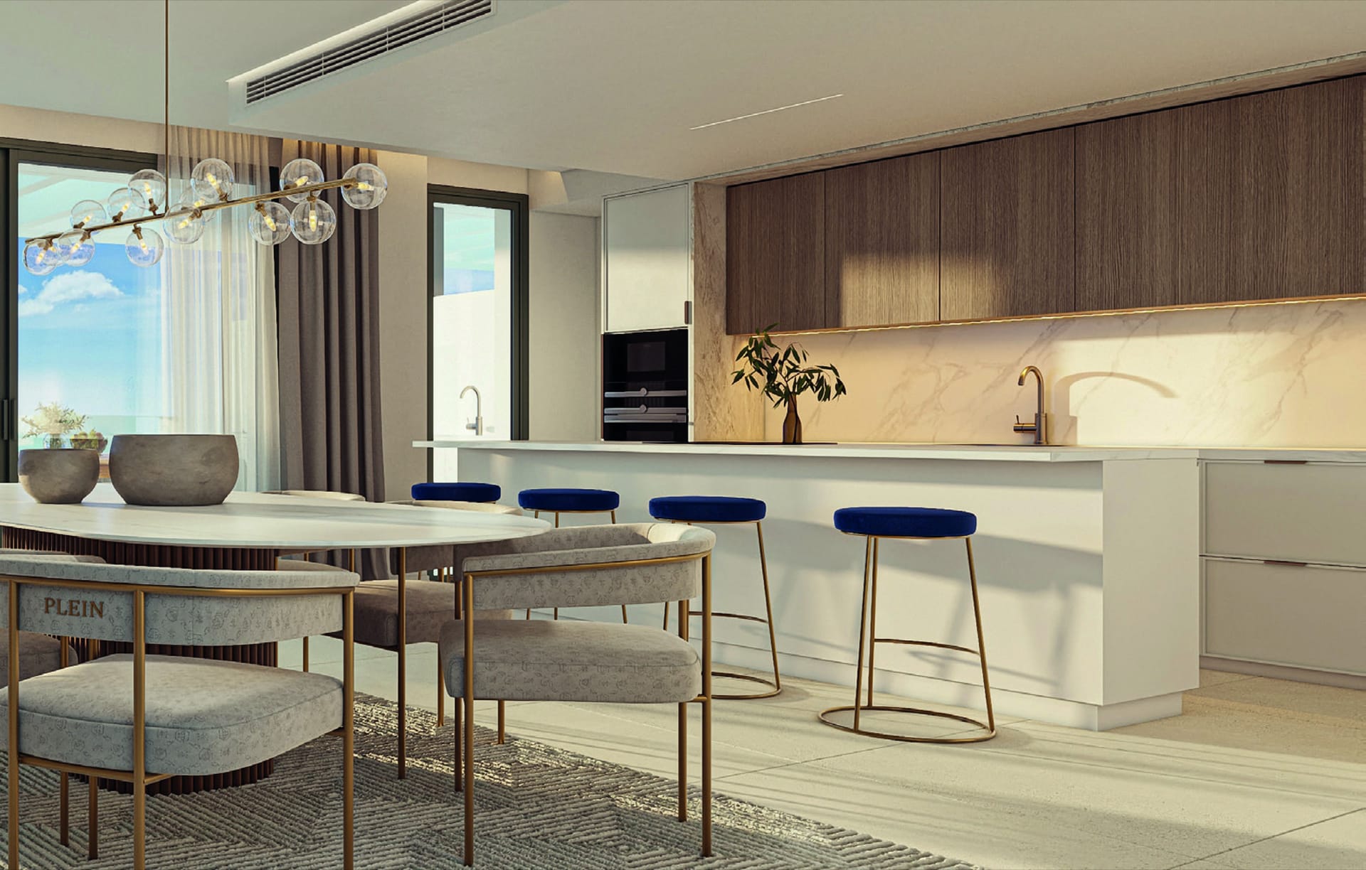 A kitchen with wood-fronted units, an island with blue stools and a dining table by the window. Soul Marbella Sunlife III, Los Monteros, Marbella.
