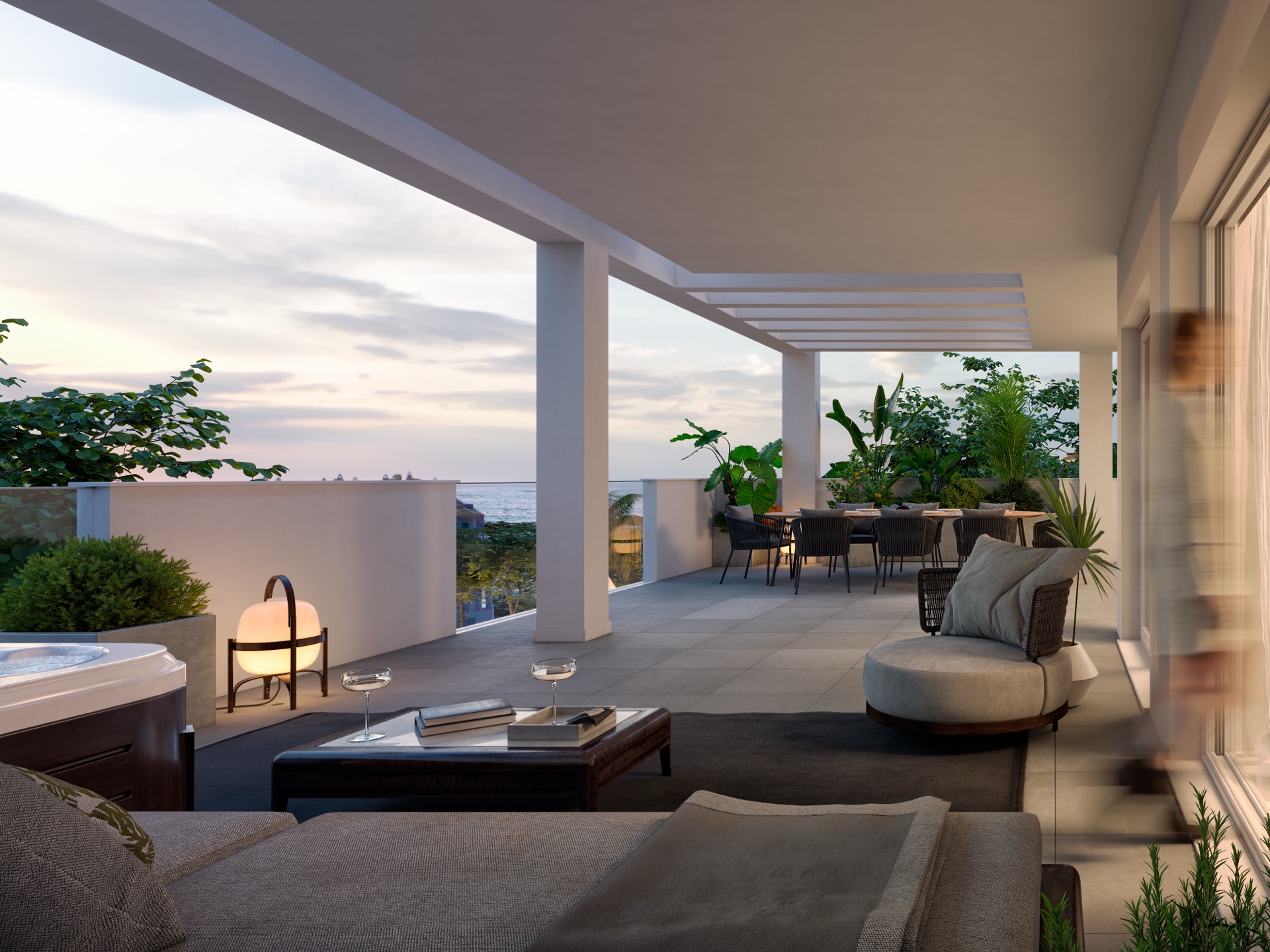 A covered terrace with an outdoor spa bath, seating and a dining table, looking out to the sea. Stella 8, Torrequebrada, Benalmádena.