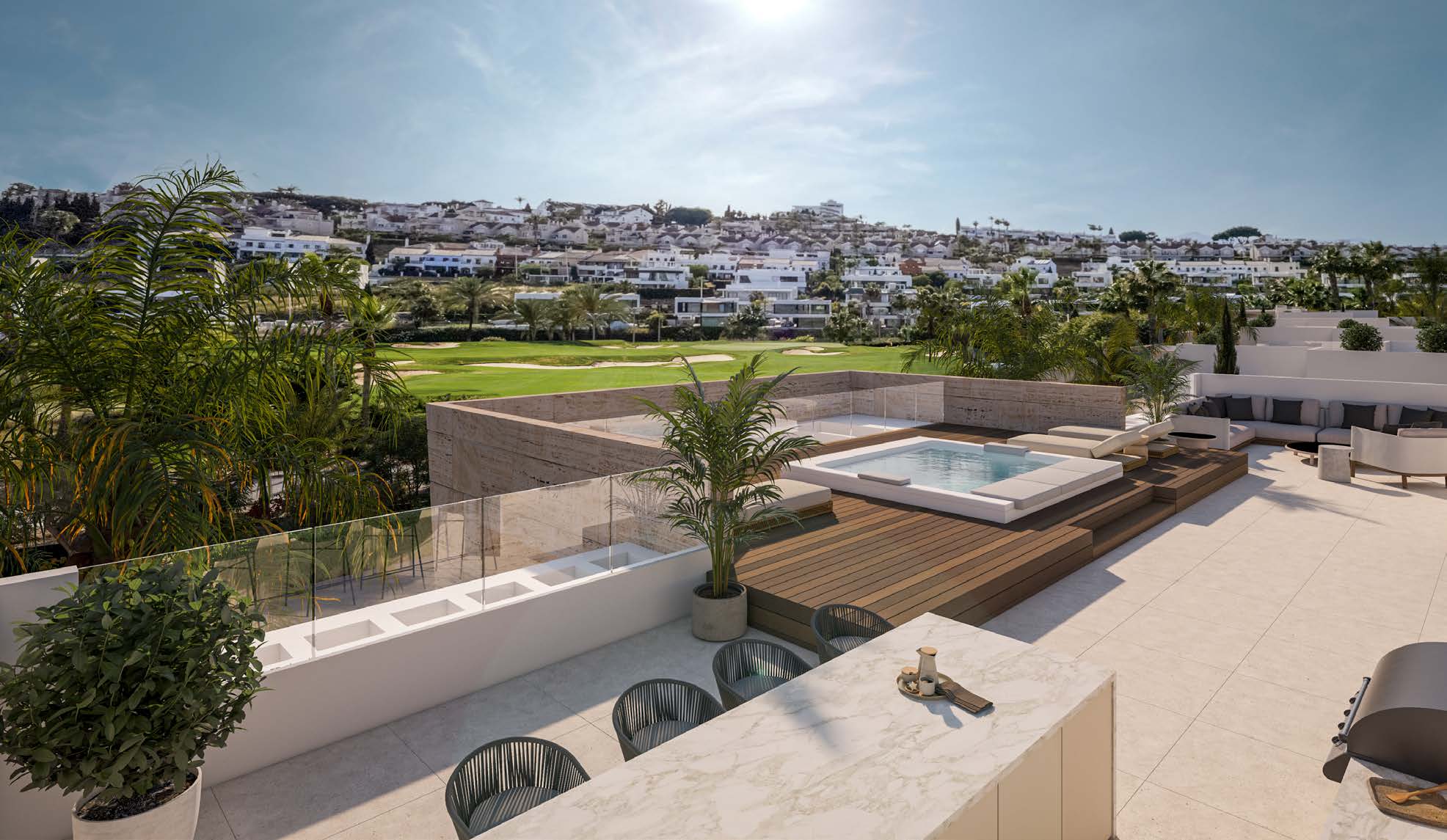A roof solarium, with the jacuzzi on raised decking and the golf course and hills beyond. The Club Villas, El Campanario, Estepona.
