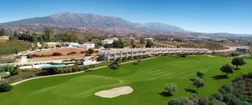 An aerial view along the Europa course to the townhouses, with the mountains behind. The Meadows, La Cala Golf, Mijas.