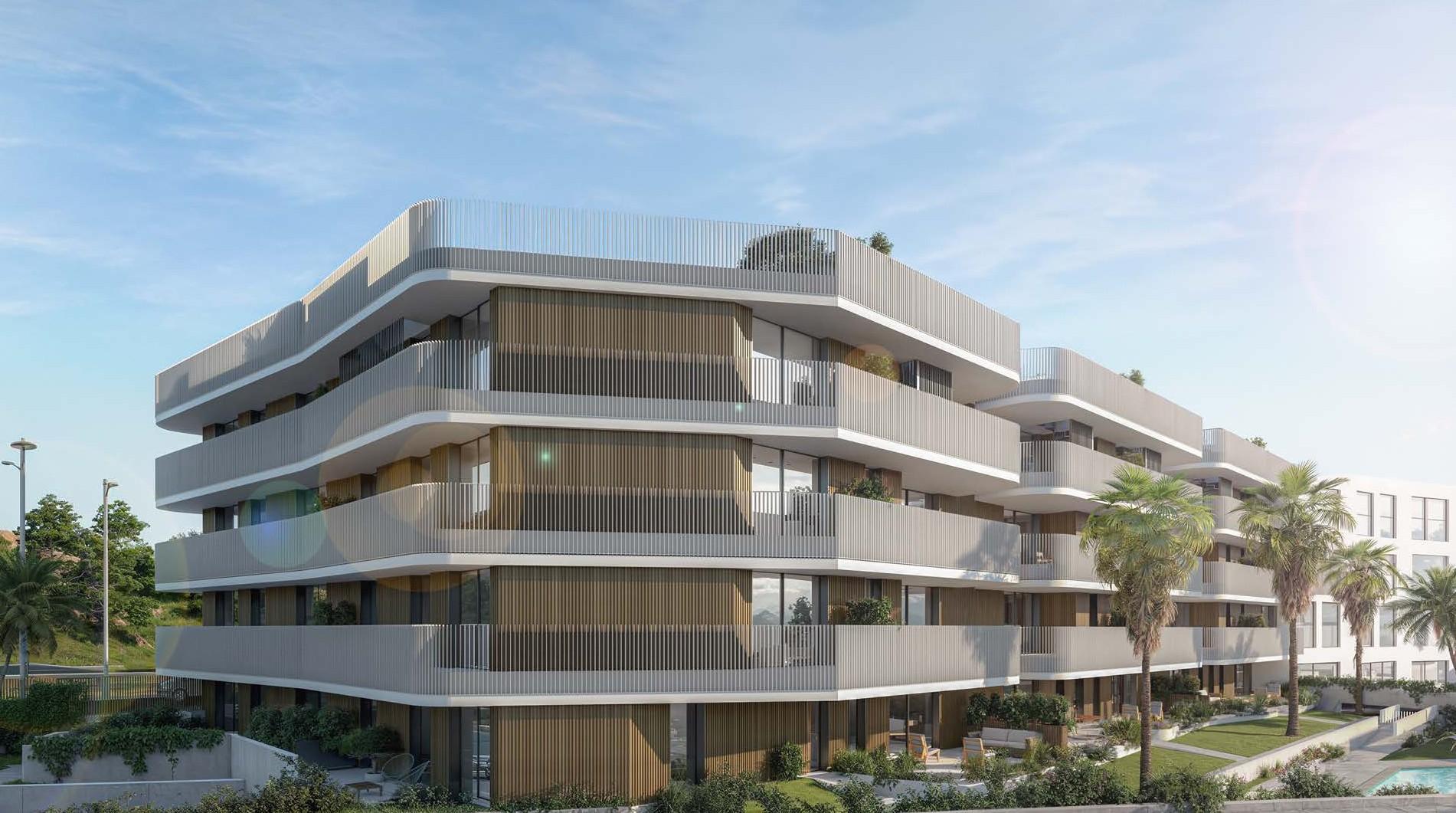 The corner of the building, with curved balconies wrapping round each floor and palms in the gardens along its side. The Oak 48, El Calvario, Estepona.