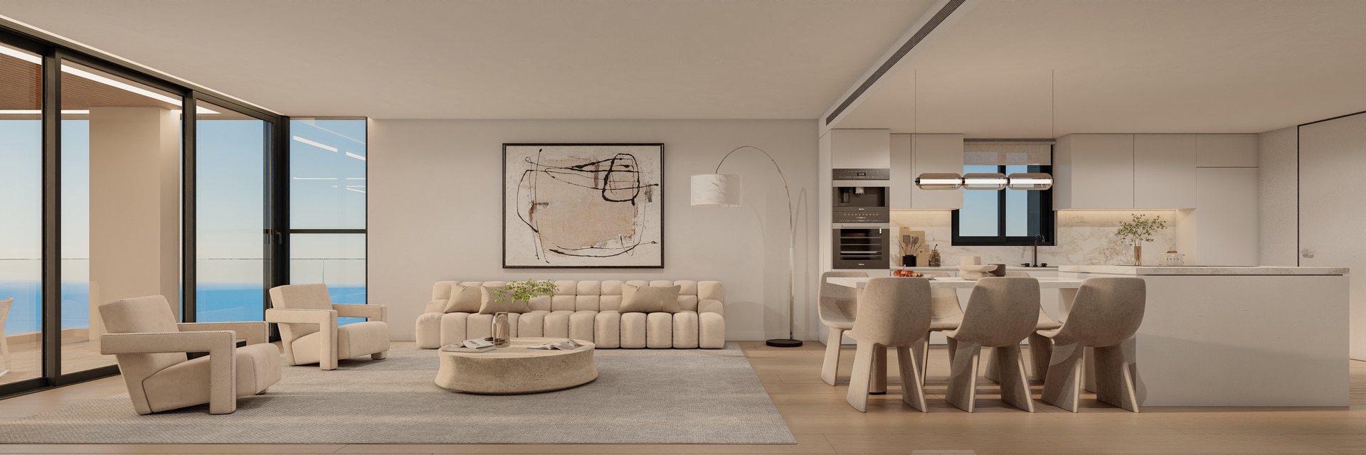 The open living room and kitchen of a three bedroom apartment. Glass doors on the left lead to the terrace, with the sea beyond, and a dining table runs off the kitchen island. Unique Infinity, El Higuerón, Fuengirola.