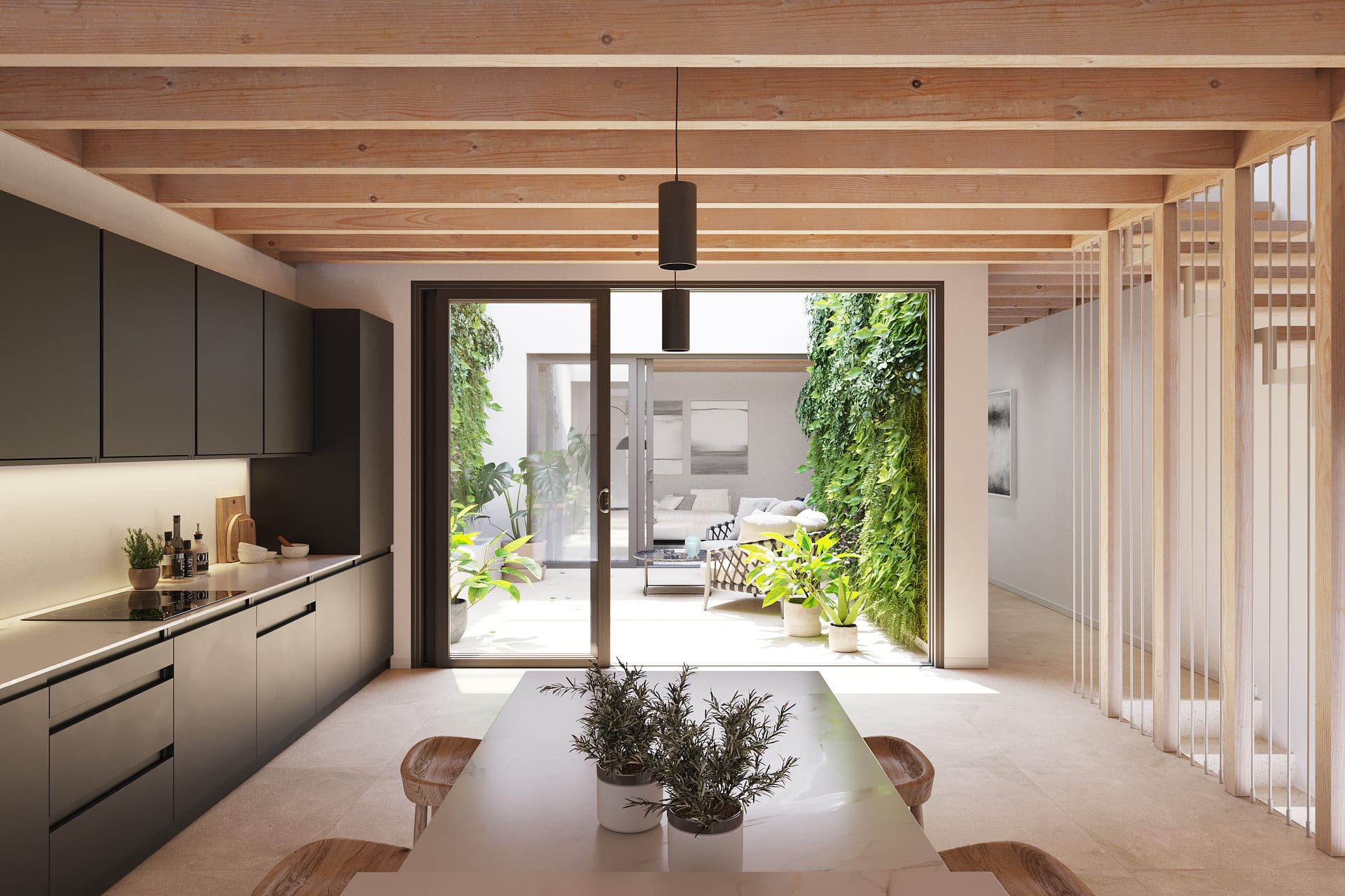 A kitchen with dark units along one wall, and glass doors at the far end opening onto a planted patio. Unique Pedregalejo, Pedregalejo, Málaga.