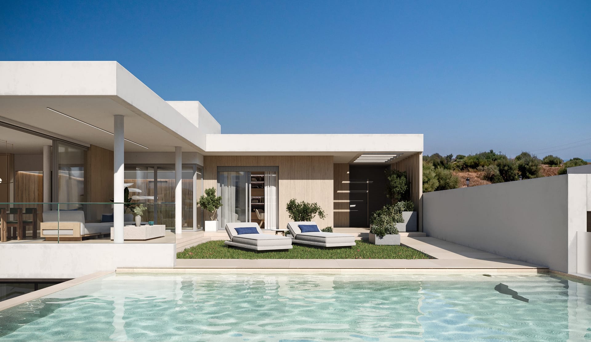 A villa’s private pool, with a lawn and two sun loungers in front of the glazed living room. Zenity Cyan, La Gaspara, Estepona.