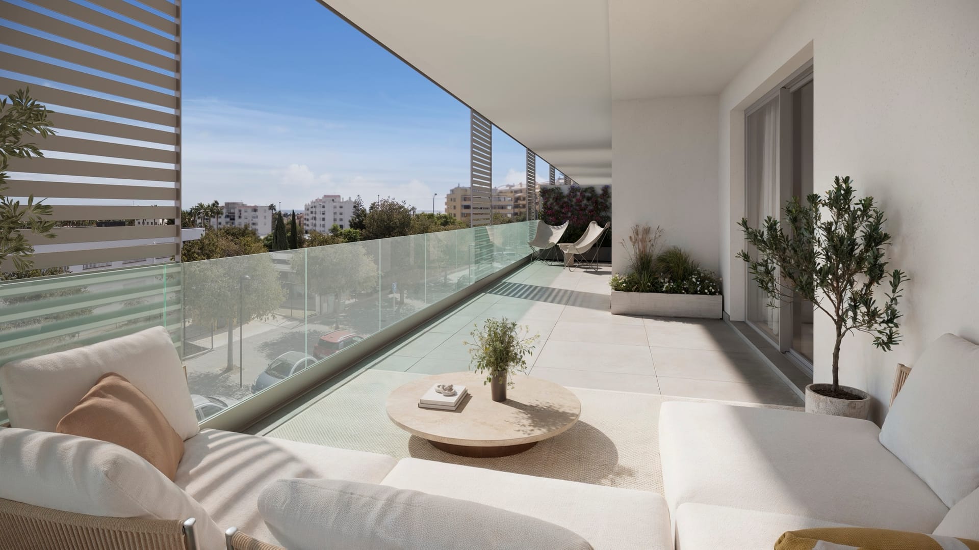 A terrace with a glass balustrade and outdoor seating. Zinnia, San Pedro Alcántara, Marbella.